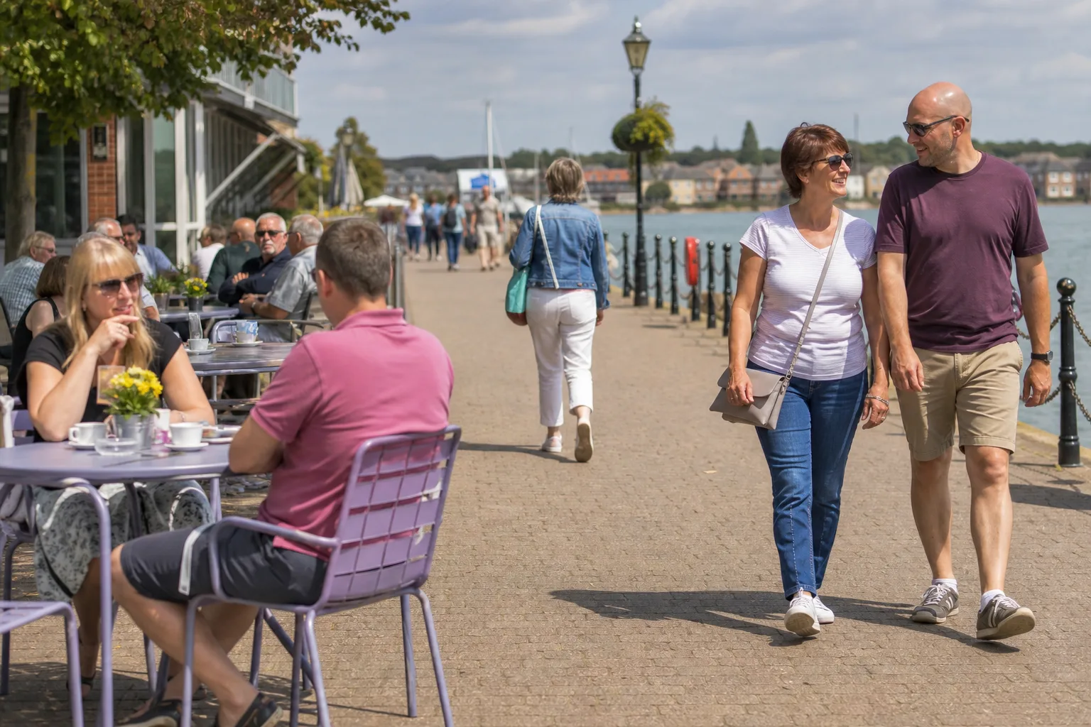 People walking and chatting beside the River Medina at Newport Quay