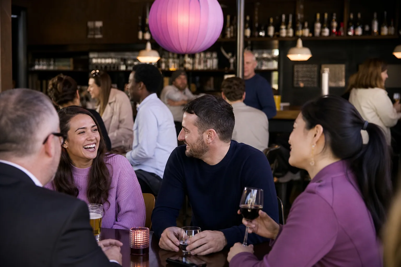 People talking together at a relaxed evening social on the Isle of Wight